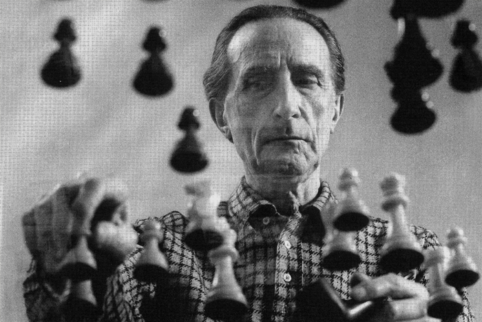 Marcel Duchamp playing chess on a sheet of Glass, 1958 © Arnold Rosenberg 